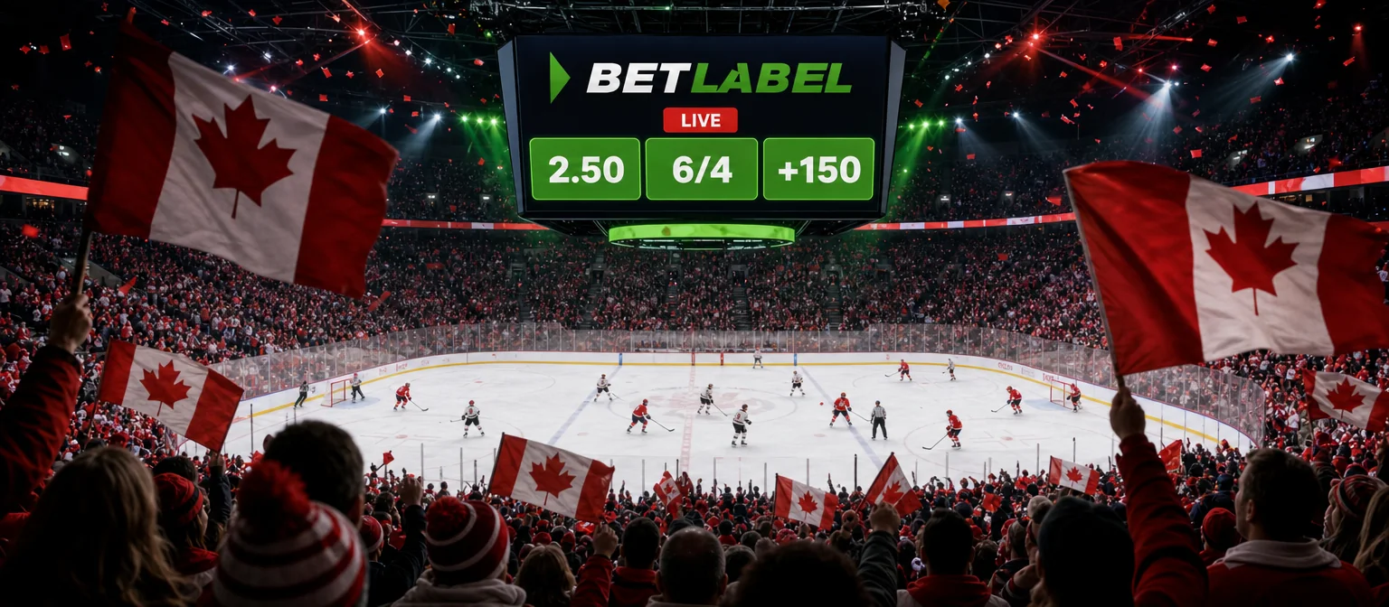 Live hockey game seen from high in the stands, with the BetLabel logo and live odds of 2.50, 6/4 and +150 on the big screen above the ice